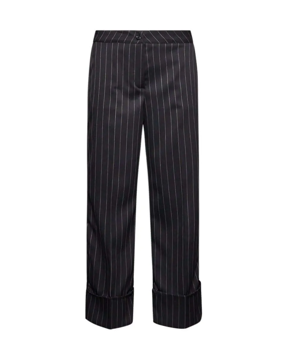 Pantalone gessato a gamba dritta in tela elasticizzata tinta unita con maxi risvolto al fondo. NERO